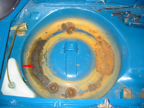 Flooded rusty spare wheel well in boot of Capri