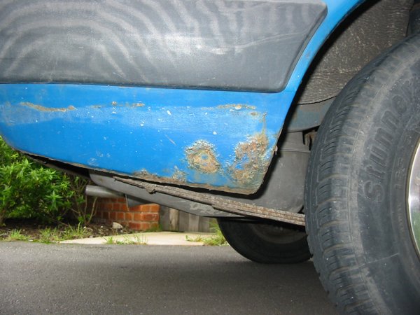 Capri offside rear lower quarter with surface rust 